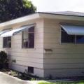 The window awnings on this house provide a simple but very effective way to reduce solar gains while still allowing view, daylight, and ventilation through the windows