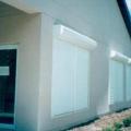 The light-colored exterior roll-down shades on this building, and the shaded entryway provide very effective control of solar heat gain