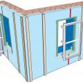 A flanged window unit is installed with straps that fasten to the interior surfaces of the plywood extension box; furring strips on each side of the window will be attached after the flanged window is installed and flashed