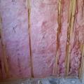 Wrong - Unfaced fiberglass batt is not properly cut to fit in all the stud bays.