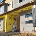 Right - Mold- and water-resistant fiber glass insulating sheathing is installed after panelized walls are assembled on site.