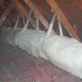 Encapsulated ducts are sprayed with ccSPF in an unconditioned attic
