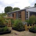 The design of this home incorporates multiple methods to reduce summertime solar gains including roll-down exterior blinds, wide exterior horizontal louvers, minimized east/west-facing windows, and vegetation.