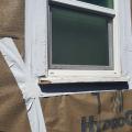 Wrong - The flashing tape is poorly adhered to the window.