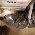 Wrong - Flex duct insulation is overly compressed in 3 ways; Zip-tie fastener is over the insualtion not under the insulation at the duct boot collar, duct turning radius is too tight, and support strap is too tight.