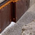 This building foundation has a drainage layer located on the exterior of the waterproofing membrane. 