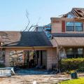 Failure of a garage door due to pressure differences under hurricane force wind conditions resulting in damage to the house.