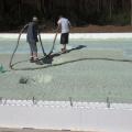 The floor slab is completely insulated with ICF foundation walls and R-20 (3 inches) of closed-cell foam that is sprayed directly onto the ground before pouring the slab. 