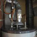 The raised hood at the base of the vent stack on this water heater shows that it is an atmospheric vented gas water heater
