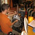 A technician assembles the spray sealant injection system to seal HVAC ducts from the inside