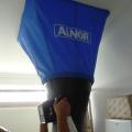 A passive flow hood is used to measure the  flow rate of air that passes through a ceiling-mounted exhaust fan 