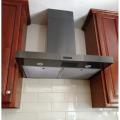 This ducted, wall-mounted range hood exhaust fan replaced a recirculating fan that did not adequately remove kitchen contaminants.  