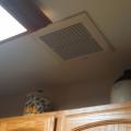 Wrong - Kitchen exhaust fans must be located directly over the stove top to be effective at capturing and removing cooking pollutants.