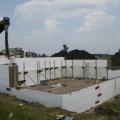 Concrete is being poured into the wall forms made by the rigid foam insulated concrete form blocks. 