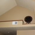 A ductless heat pump is hidden behind a wall outcropping above the hallway ceiling. 