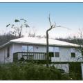 This hip-roofed home survived high winds with little to no damage. 