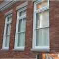 The addition of low-E permanent exterior storm windows is typically accepted for most historic preservation projects