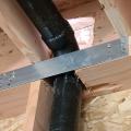 Wrong - Hole in rim joist was cut too large for plumbing pipe and the gaps are not air sealed.