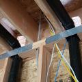Wrong - Holes in rim joists were cut too large for plumbing pipes and gaps should be air sealed.