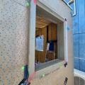 Right - Corners of window are protected with draining house wrap that laps onto the sides of the window trim, paint-on flashing at window trim corners, and self-adhered flashing to reinforce corners.