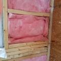 Wrong - Insulation beneath window is compressed and there are more support studs than necessary to left of window.