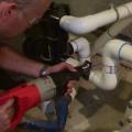 A reciprocating saw works well to cut PVC pipe during pool pump installation