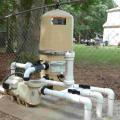 Variable-speed pump with low head loss filter and piping layout