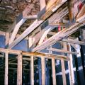 Where the interior wall intersects the corridor wall in this multifamily building, the first intersecting wall stud is sealed to the corridor wall along both sides; other seams and penetrations in the exterior wall are also sealed