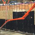 Right - This waterproofing membrane on the interior of a deep soldier pile foundation with wood lagging is continuous, and penetrations through the membrane have been sealed. 