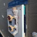 Right - Metal drip edge flashing is installed above hose bib and top of metal flashing is taped to wall.