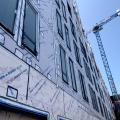 The windows in this building are connected to the fully adhered water and air control layer using fluid-applied flashing 