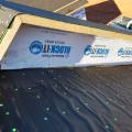 Wrong - Nailing pattern on roof underlayment is erratic and excessive, house wrap should overlap seam, metal step flashing will need to be installed at roof-wall junction.