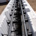ICF blocks used for the foundation walls consist of two sheets of rigid foam held together by plastic spacers and reinforced with steel bars forming a hollow wall that is filled with concrete for an ultra-efficient foundation system.