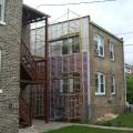 In this exterior wall retrofit of a masonry brick home, first the brick was covered with a fluid-applied water and air control layer (white), then 2x4 furring strips and two layers of rigid foam insulation, then 1x4 furring strips to attach cladding to