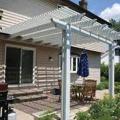 The south face of this home has an overhanging second floor, a pergola, and a roof eave to provide effective window and door shading for both floors in the summer without blocking view, diffuse daylighting, breezes, or ingress/egress