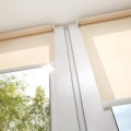 Interior window attachments such as these light-filtering roller shades can reduce heat gains while providing pleasant, diffuse natural light. 