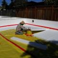 Right--The polyethylene ground cover for this insulated crawlspace is taped at seams and around posts before the insulation and slab are installed. 