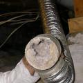Wrong –Excessive length and a vertical angle on this dryer duct reduced air flow allowing the dryer duct to become completely clogged with dryer lint