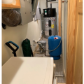 Right: This heat pump water heater is installed in a utility closet where it can use heat from the clothes washer and heat pump clothes dryer and has access to a floor drain for condensate
