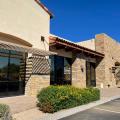 Right – this commercial building employs good techniques to resist solar heat gain:  awnings and pergolas over windows, recessed windows and entryways, deep tinting on glass, and shade plants.