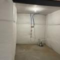 Right - The blanket fiberglass insulation is installed over a continuous layer of rigid foam insulation; the fiberglass is covered with a vapor retarder that is tape sealed at the seams.