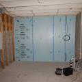 Right - XPS rigid foam board is tightly installed against a concrete foundation wall and seams are sealed with tape prior to installing fibrous blanket insulation.