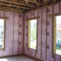 Masonry walls can be insulated with rigid foam insulation attached to the interior face of the concrete block as shown here.