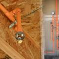 A roughed-in fire sprinkler head (left) and fire sprinkler riser (right), both using CPVC piping.