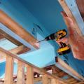 This Habitat for Humanity builder ordered roof trusses with a 2-foot by 2-foot notch next to the center post then lined the cutout with rigid foam to form an insulated central duct chase to bring the heating and cooling ducts within the conditioned space.