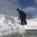 If snow level is estimated to exceed roof load limits, snow removal may be needed; hire professionals 