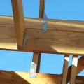 Bolted metal hurricane strapping ties the roofing to the framing and the framing to the foundation walls for resistance to high winds.