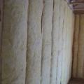 Unfaced fiberglass batt insulation is installed to completely fill the wall cavities and is sliced to fit around wiring, piping, and other obstructions in the wall cavities
