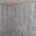 Blown cellulose insulation completely fills the netted wall and ceiling cavities