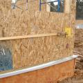 Lifting plates attached to the wall provide good bracing to tighten up SIP panel seams